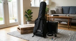 A black padded guitar gig bag with backpack straps, shown alongside a beginner electric guitar starter pack.