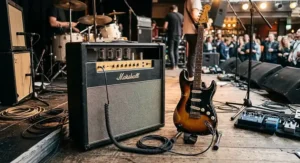 A premium gigging electric guitar connected via lead cable to a classic British valve amplifier.