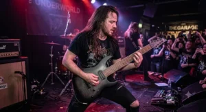 Musician performing on stage with an extended range 8 string electric guitar at a British music venue