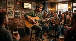 Guitarist strumming a 12-string acoustic guitar during an intimate acoustic gig at a British venue.