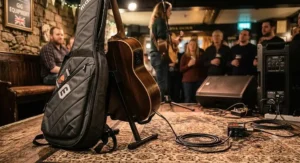 Stage-ready electro acoustic guitar for live performance resting next to a protective gig bag