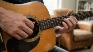 Examining the strings of an acoustic bass guitar for beginners to check tension and thickness.