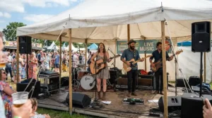 A band performing with a modelling amp for gigging at an outdoor summer festival marquee